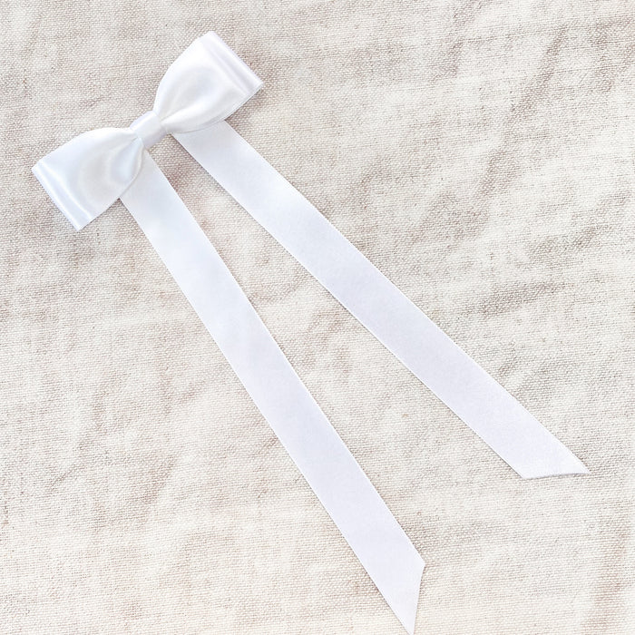 Little Love Fleur White Satin Hair Bow Barrette image shot on natural linen background