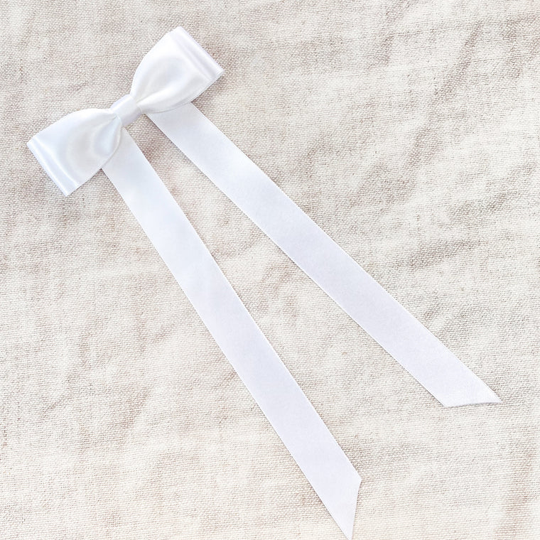 Little Love Fleur White Satin Hair Bow Barrette image shot on natural linen background