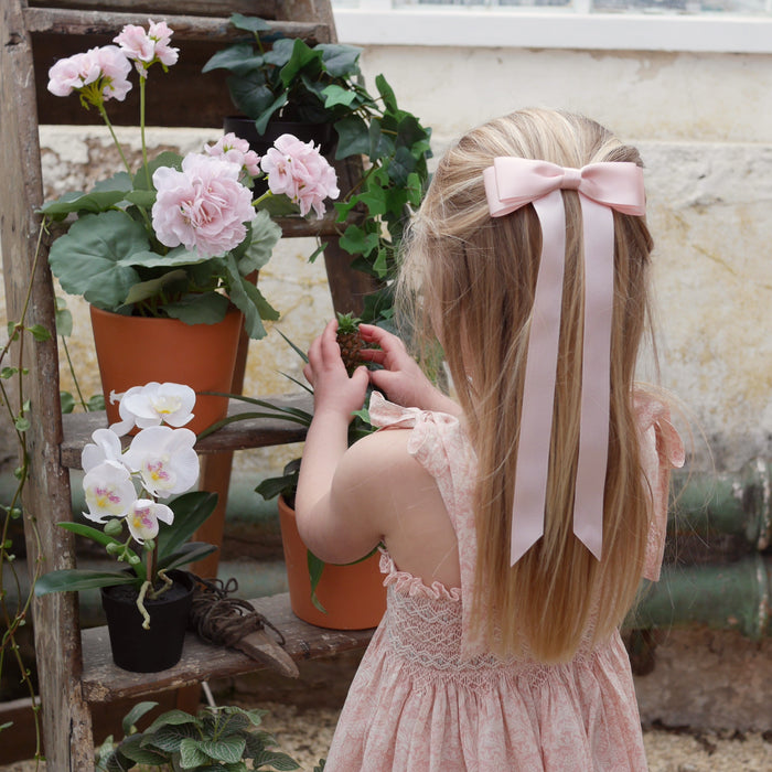 Little Love Fleur Satin Bow Barrette in Pink, Oversize satin hair bow, pale pink satin hair bow, silk satin hair bow uk, pink bow for little girll, flower girl bow satin, large silk bow in hair, pink satin bow on little girl with long hair,  pink satin bow barrette, hair bow in pink satin, little girl wearing pink bow,  pink hair accessory