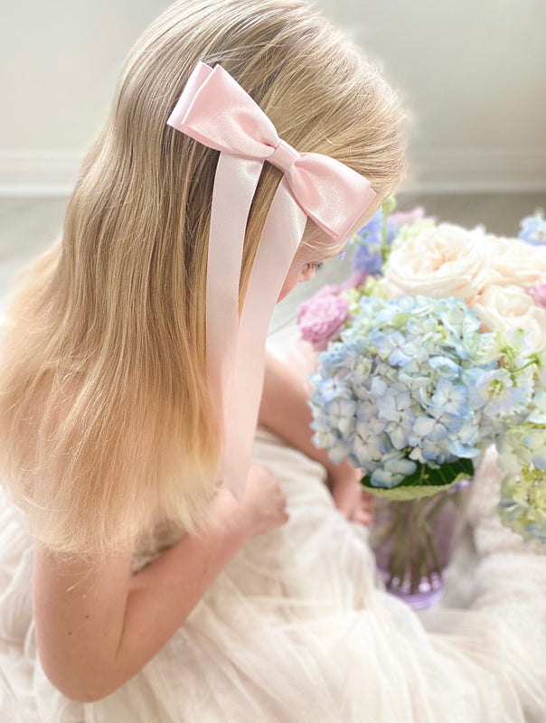 Little Love Fleur Satin Bow Barrette in Pink, Oversize satin hair bow, pale pink satin hair bow, silk satin hair bow uk, pink bow for little girll, flower girl bow satin, large silk bow in hair, pink satin bow on little girl with long hair,  pink satin bow barrette, hair bow in pink satin, little girl wearing pink bow,  pink hair accessory