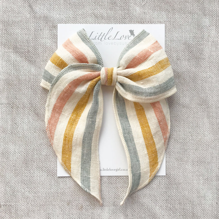  rainbow stripe linen bow hair clip for girls, rainbow cotton bow hair clips, muted rainbow hair bow, neutral rainbow bow hair clips, little love handmade hair bows, childrens hair accessorries uk, luxury kidswear uk, girls hair bows, mustard rainbow hair bow, linen hair bow, hair bows uk, stripe linen bow 