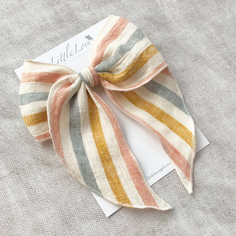  rainbow stripe linen bow hair clip for girls, rainbow cotton bow hair clips, muted rainbow hair bow, neutral rainbow bow hair clips, little love handmade hair bows, childrens hair accessorries uk, luxury kidswear uk, girls hair bows, mustard rainbow hair bow, linen hair bow, hair bows uk, stripe linen bow 