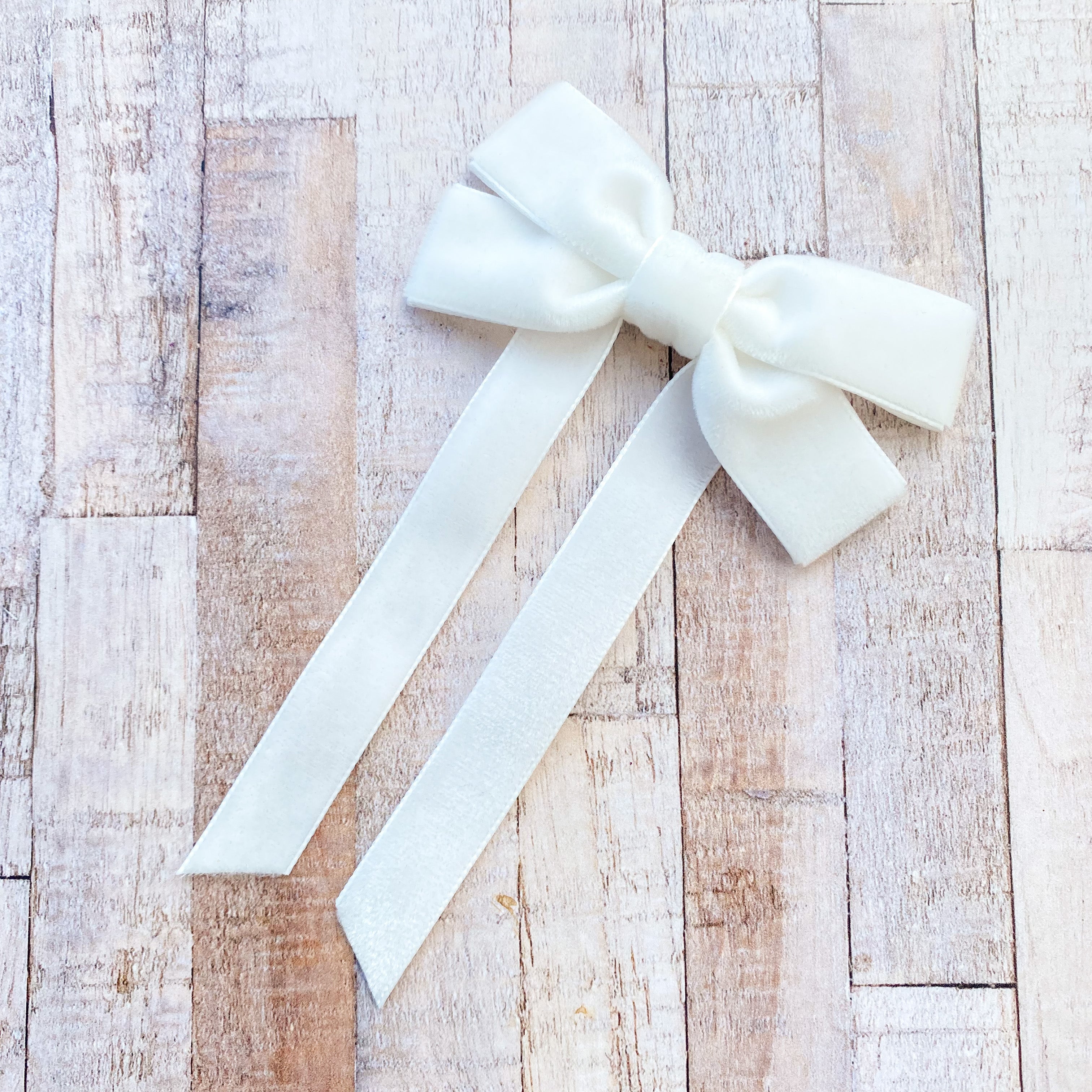 Fable Petite Velvet hair bow in pale Ivory, perfect for everyday, and special occasions, ivory velvet hair bow, ivory velvet hair bow, velvet hair bow uk, ivory flower girl bow, ivory velvet bow clip, ivory bow for flower girl, velvet bow hair clip in ivory, long velvet hair bow in ivory